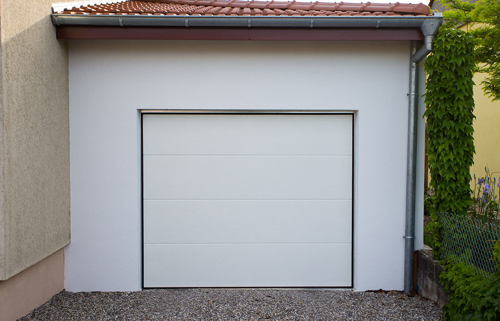 Agrandissement de maison : garage en ossature bois avec enduit extérieur