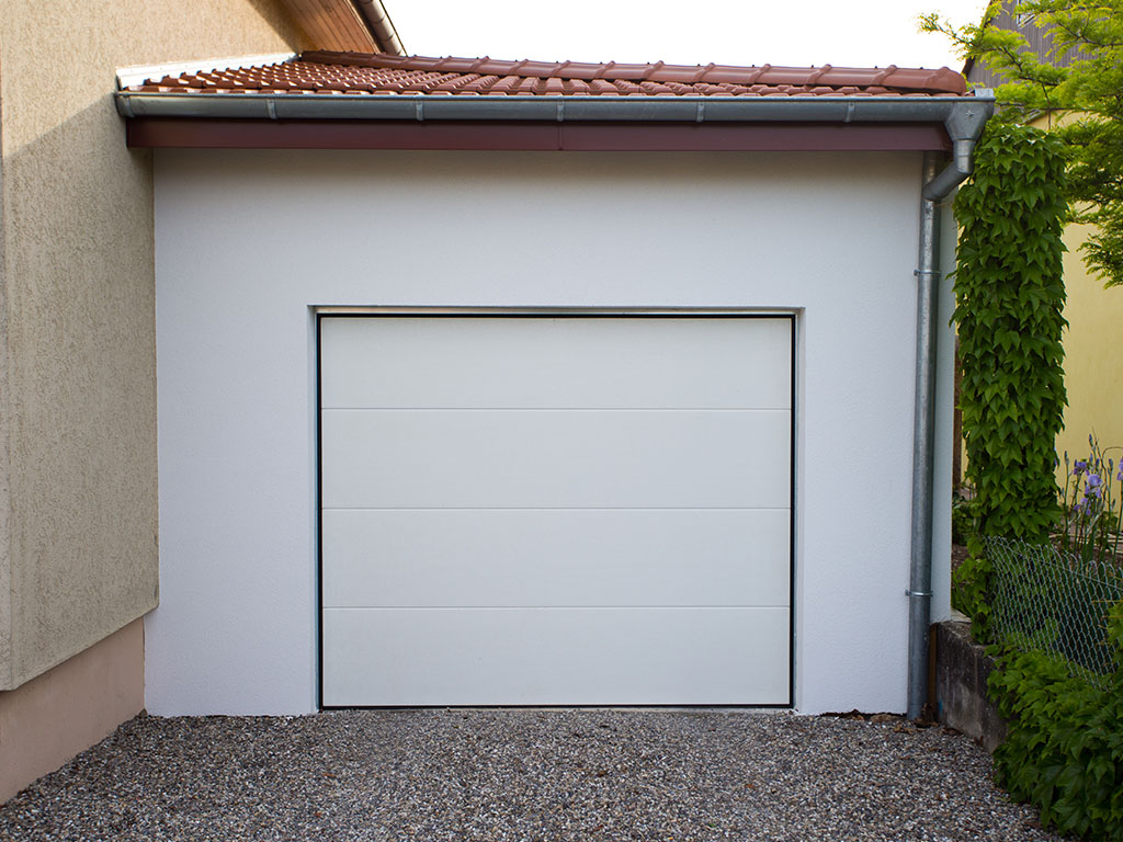 Agrandissement de maison : garage en ossature bois avec enduit extérieur